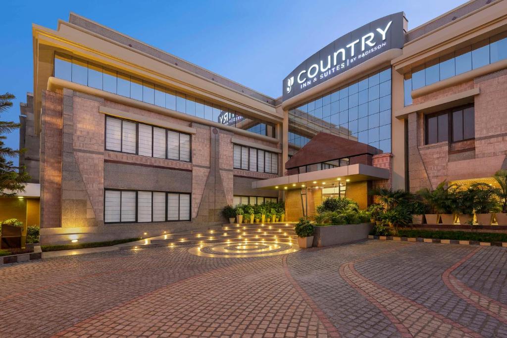 a building with a courtyard in front of it at Country Inn & Suites By Radisson Jammu in Jammu