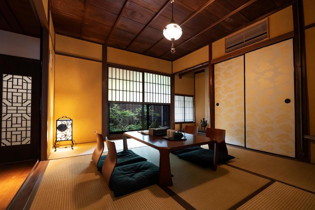 a dining room with a table and chairs at KyoMachiya Stars in Kyoto