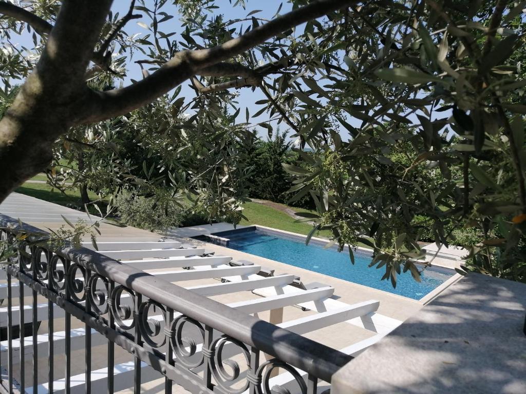 a row of lounge chairs next to a swimming pool at Stancija Ruseti in Oprtalj