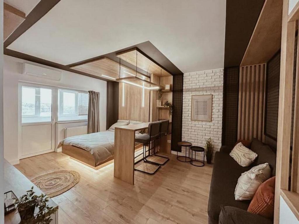 a bedroom with a bed and a desk in a room at Genesis - Iasi City Center in Iaşi