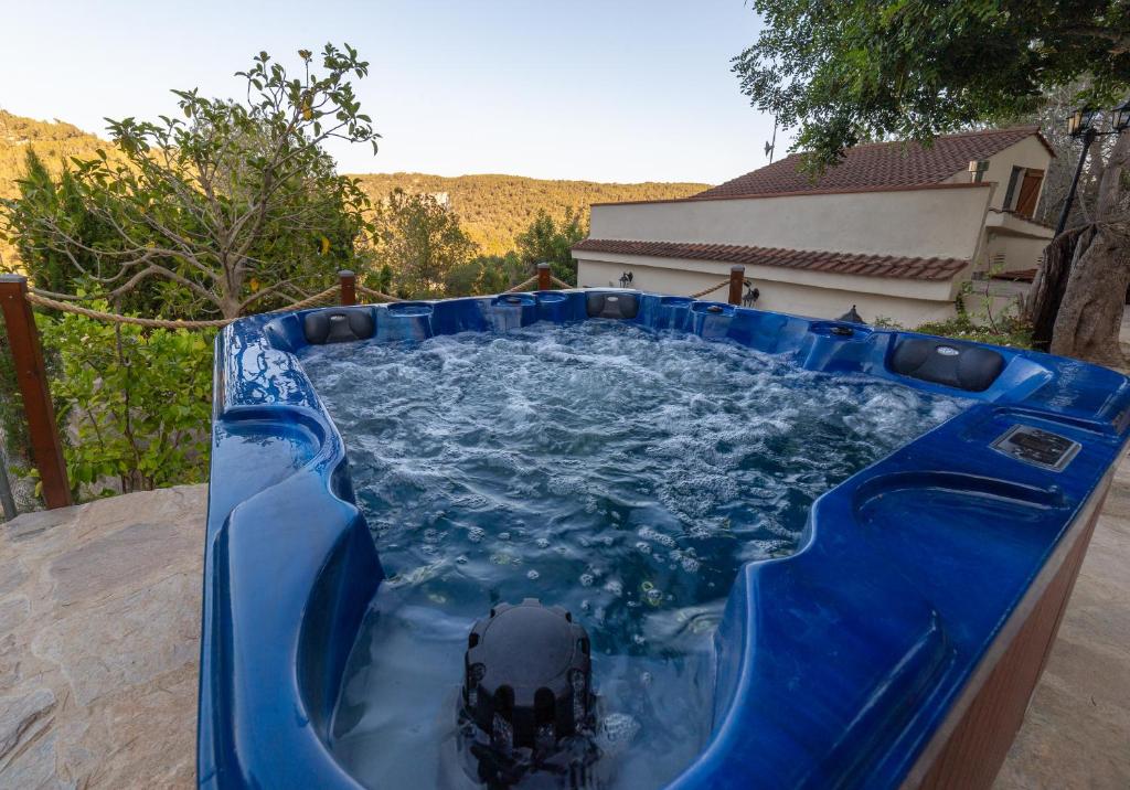 uma grande piscina azul com um objecto preto em SILOM HOUSE em Sant Pere de Ribes