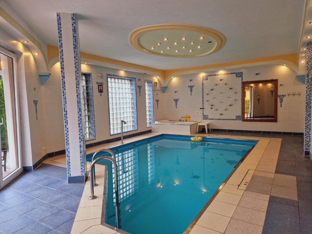a large swimming pool in a house with a tub at Apartament the Sun in Rewal