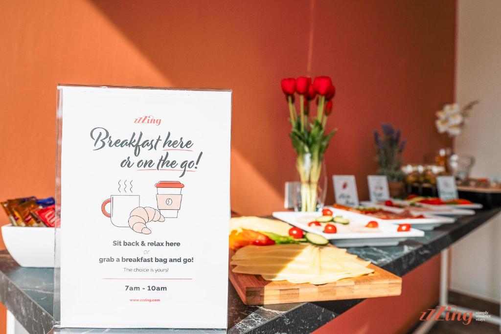 a table with a sign for a breakfast table in the end at Spinola Stays in St. Julianʼs