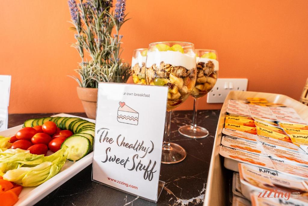 a table topped with a tray of food and a sign at Spinola Stays in St. Julianʼs