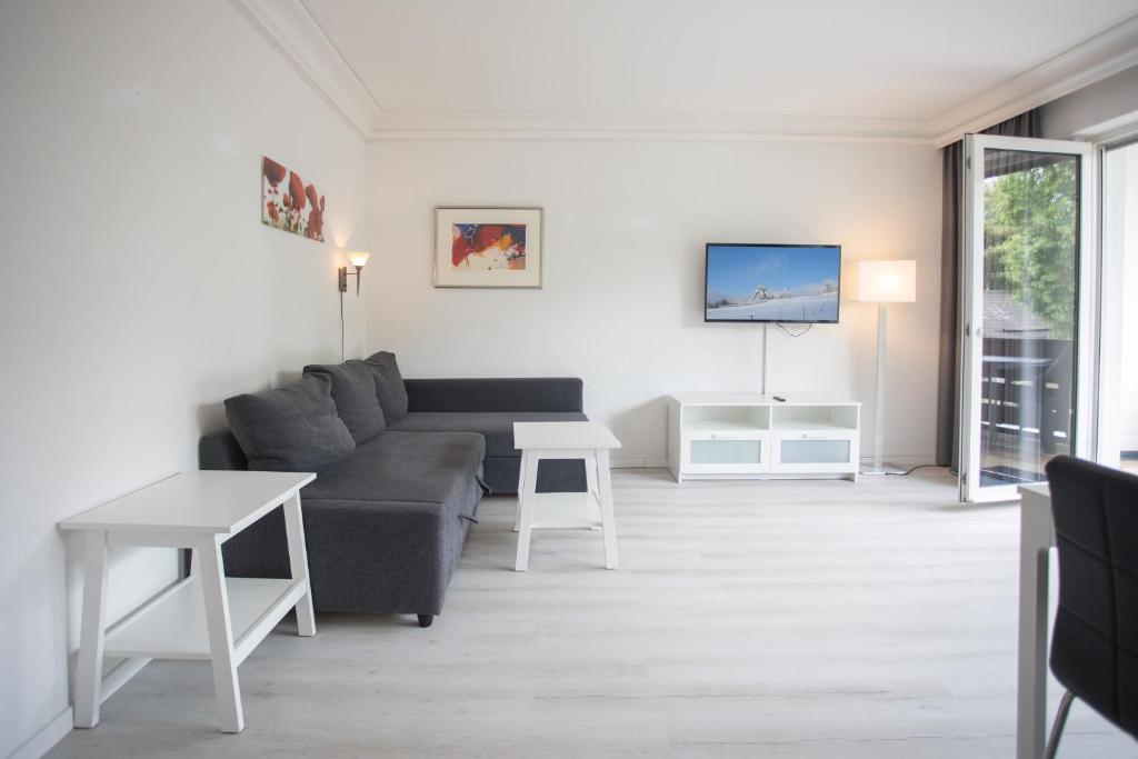 a living room with a couch and a table at Appartement Brink Fichtenweg 41 in Winterberg