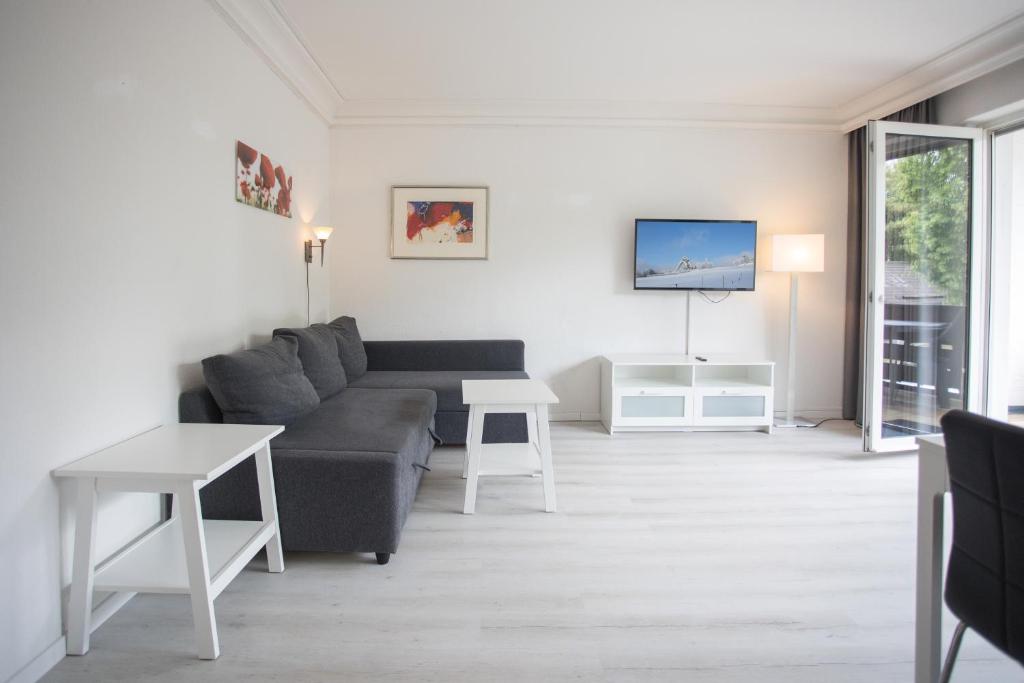 TV a/nebo společenská místnost v ubytování Appartement Brink Fichtenweg 41