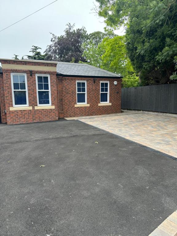 a brick house with a driveway in front of it at Newland Park Bungalow Near Hull Uni Free Parking Free Wi-Fi in Hull