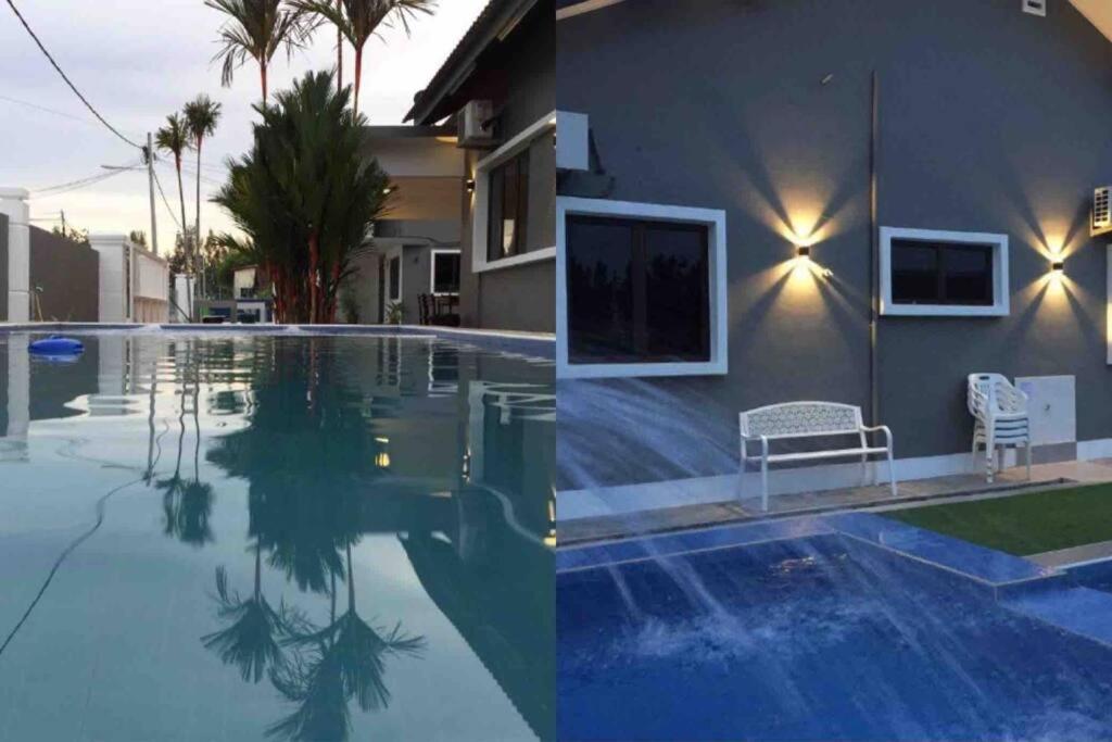 ein Haus und ein Pool vor einem Haus in der Unterkunft Melaka Beach Villa in Malakka