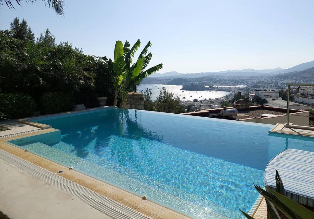 a large blue swimming pool on top of a building at Villa Castello in Bodrum City