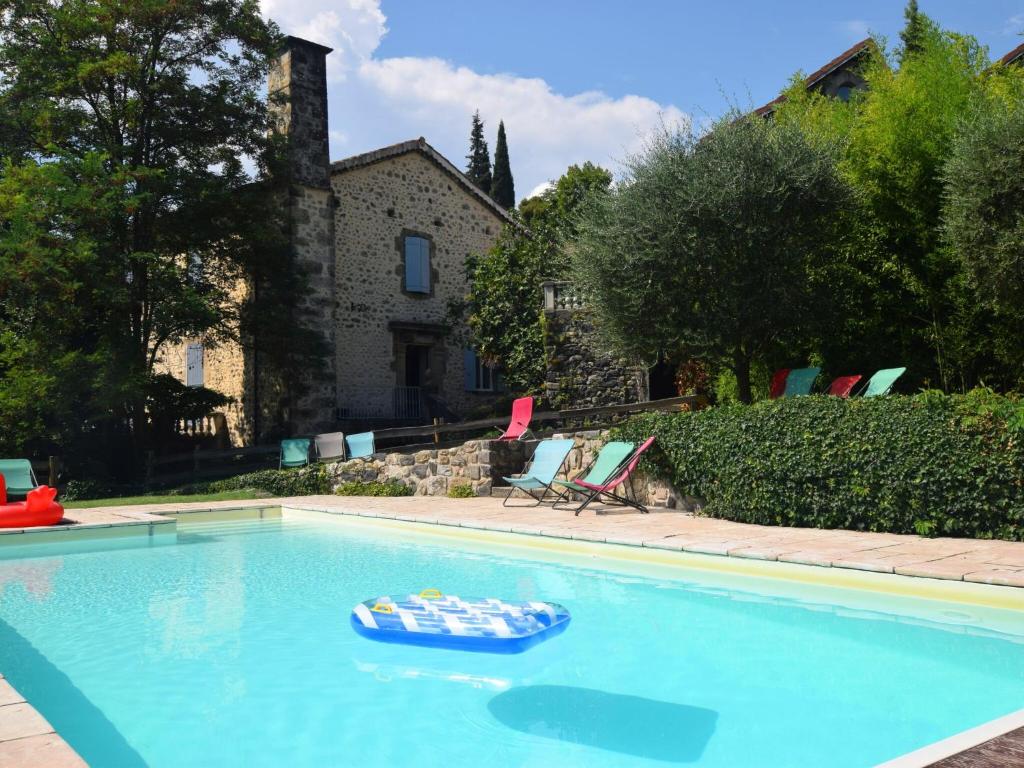 a blue swimming pool with a toy boat in it at Lovely house with grass garden shared swimmingpool next to the river Ard che in Lalevade-dʼArdèche