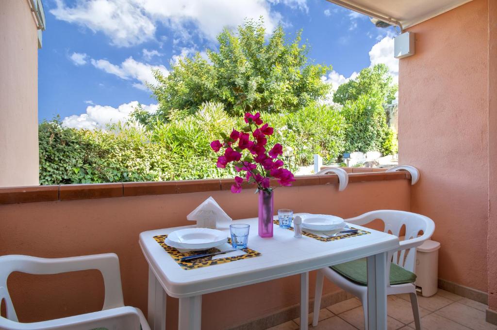 stół z wazą kwiatów na balkonie w obiekcie Casetta Brandinu w mieście Sassari