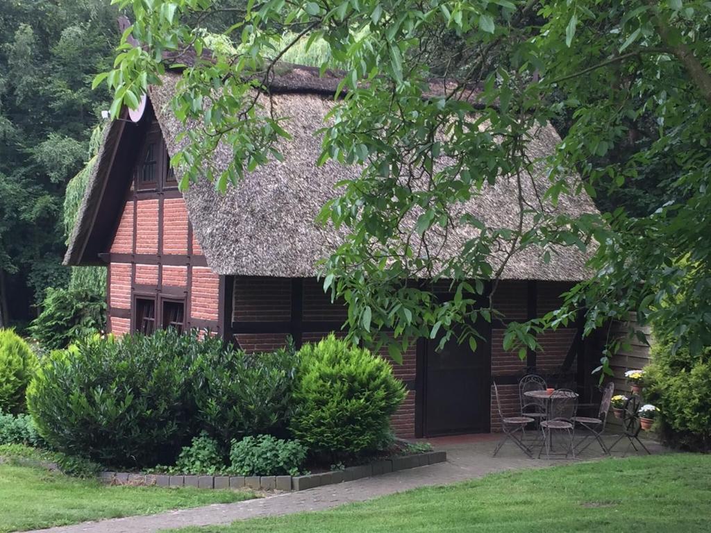 a house with a thatched roof and a patio at Holiday Home in Kirchdorf with Swimming Pool Terrace Garden in Kirchdorf