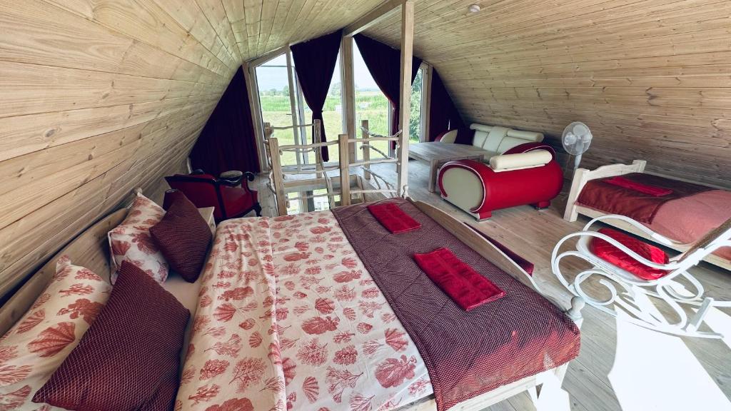 a room with a bed and chairs in a tent at Saulėlydis in Dreverna