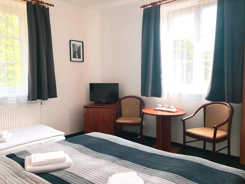 Postel nebo postele na pokoji v ubytování Hotel Karolina