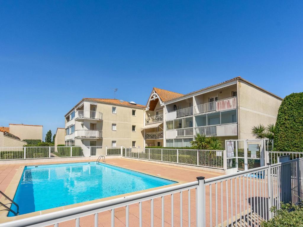 uma piscina em frente a um edifício de apartamentos em Apartment Les Jardins de l'Océan-10 by Interhome em Pontaillac