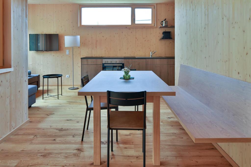 a kitchen with a table and chairs in a room at Bergreich Appartement 3 in Schoppernau