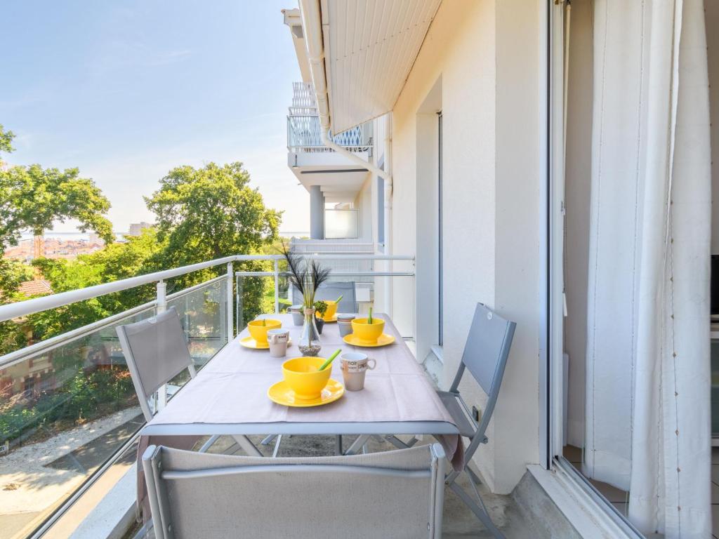 a table and chairs on a balcony with a view at Apartment Zéphyr-1 by Interhome in Arcachon