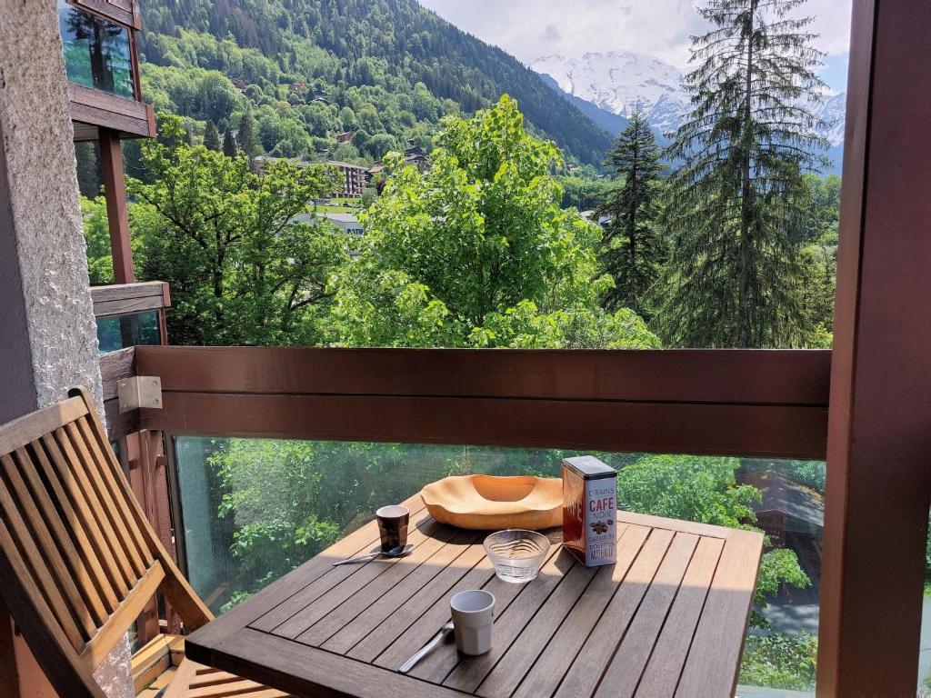 a table on a balcony with a view of a mountain at Studio Castel des Roches-2 by Interhome in Saint-Gervais-les-Bains