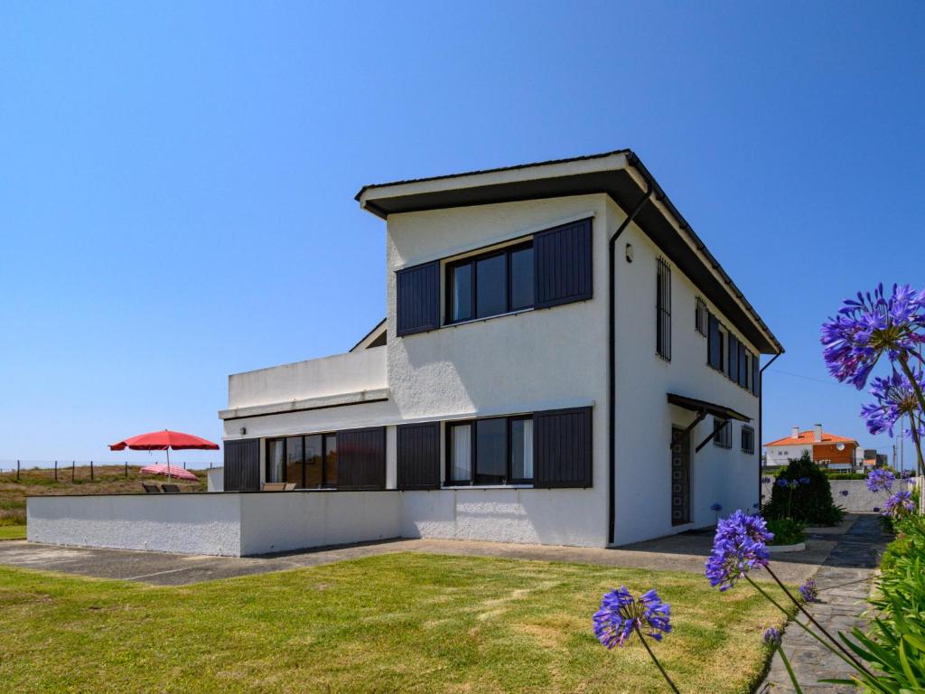 a white house with a black roof at Holiday Home De Carreço - CRR100 by Interhome in Carreço