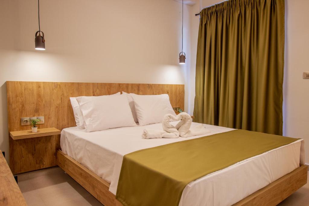 a bedroom with a large bed with a green curtain at Haus Riviera in Asprovalta