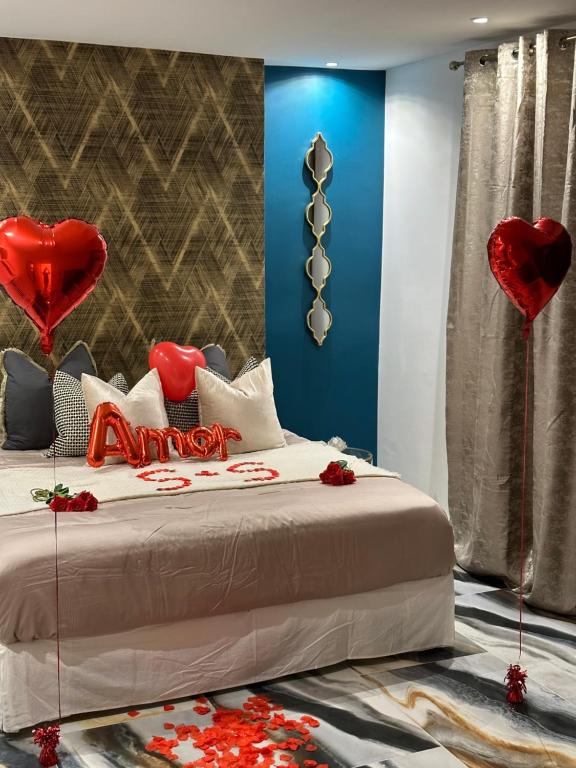 a bedroom with a bed with red hearts on it at Suite de prestige avec spa & cinéma in Ivry-sur-Seine