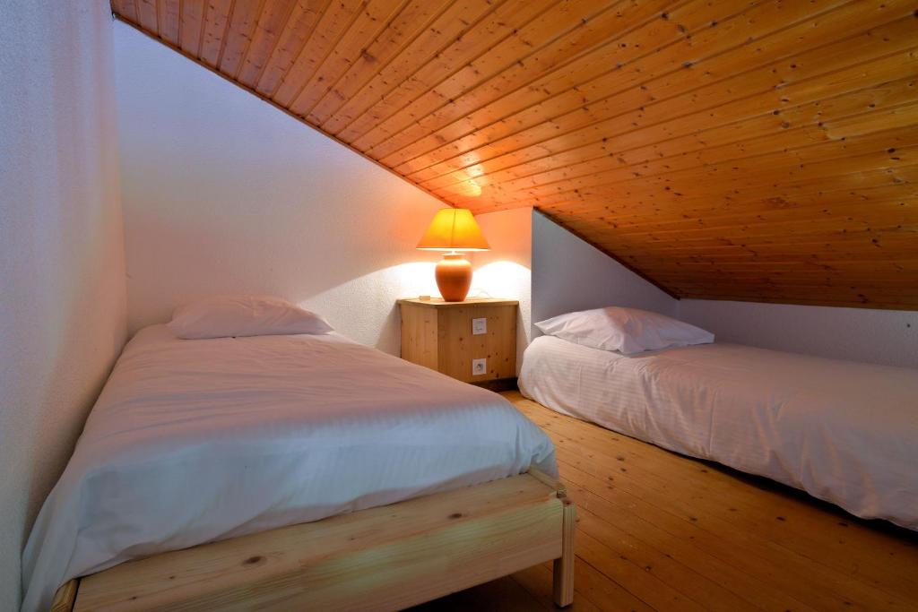 Postel nebo postele na pokoji v ubytování Résidence Joséphine