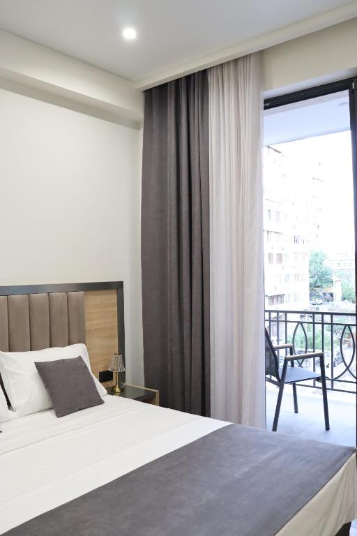 Postel nebo postele na pokoji v ubytování Orion ApartHotel