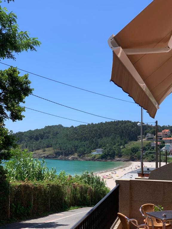 a view of the beach from the balcony of a resort at Hotel Punta Seame in Portonovo