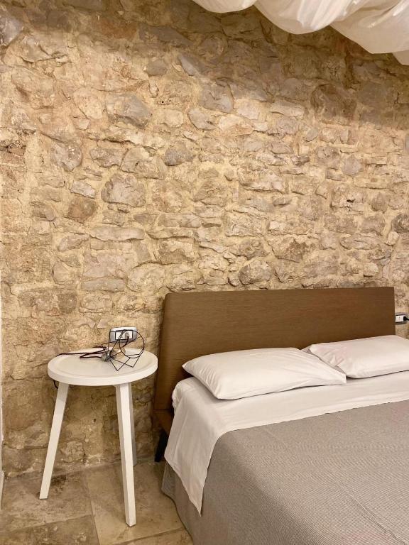 Postel nebo postele na pokoji v ubytování Altrelli Rooms