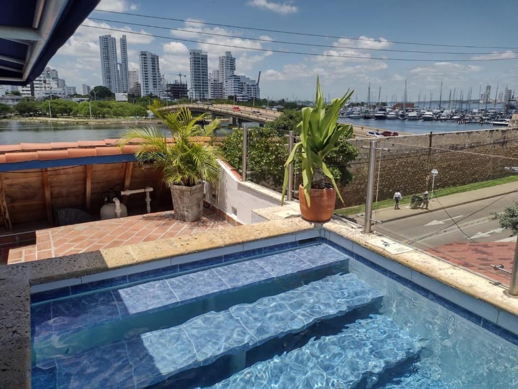 a swimming pool with a view of a city at Casa Marqués del Pedregal in Cartagena de Indias