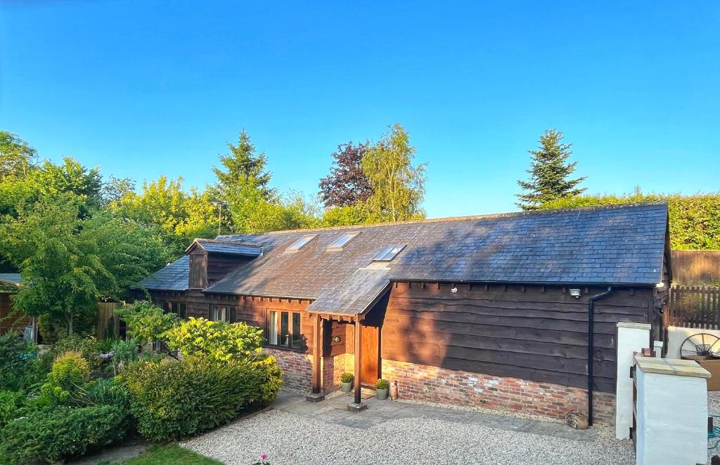 an old house with a gambrel roof at Willow Brook in Blandford Forum