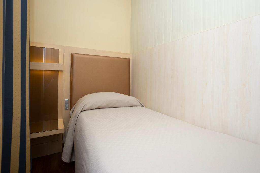 Postel nebo postele na pokoji v ubytování Hotel Velino