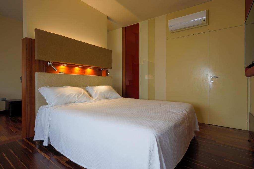 Postel nebo postele na pokoji v ubytování Hotel Velino