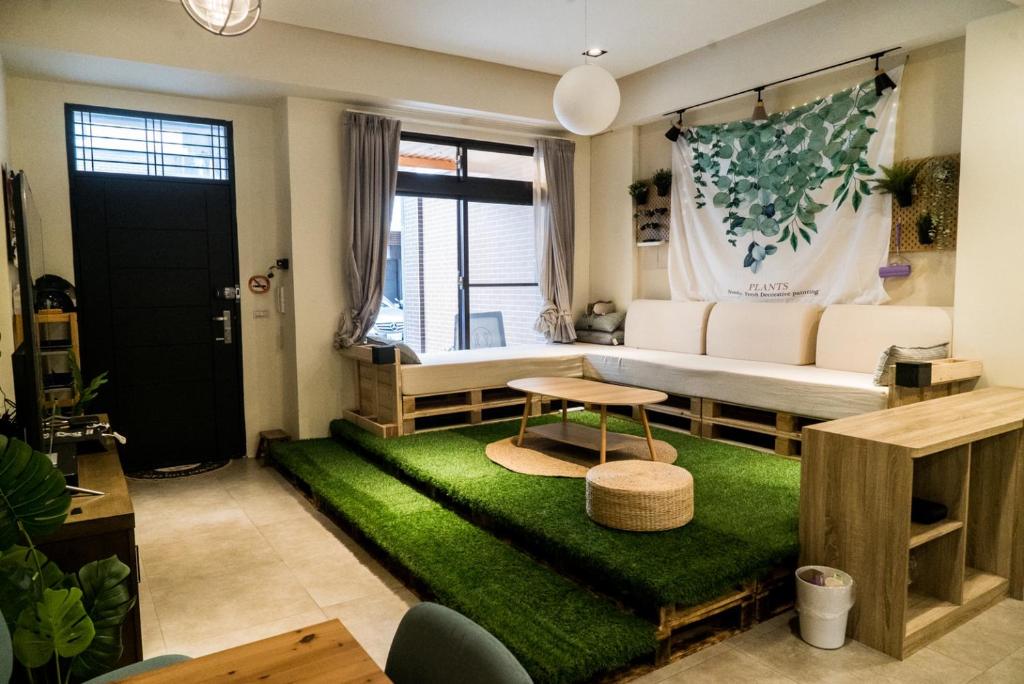 - un salon avec un canapé et un tapis vert dans l'établissement 礁溪夜室, à Jiaoxi