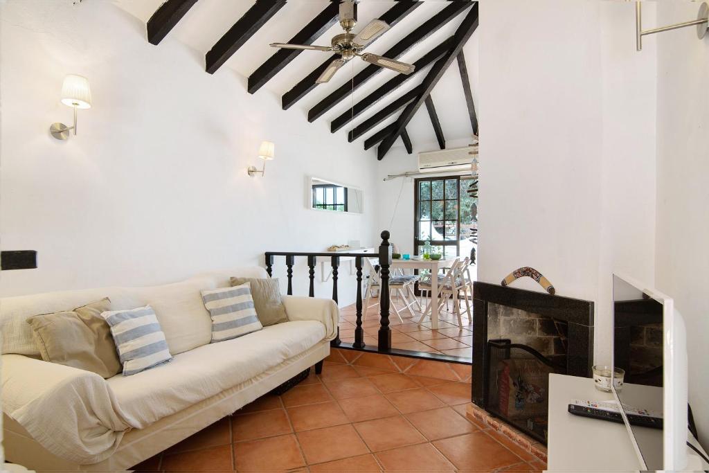 ein Wohnzimmer mit einem Sofa und einem Kamin in der Unterkunft Perogil Sunrise 141 in Cabanas de Tavira