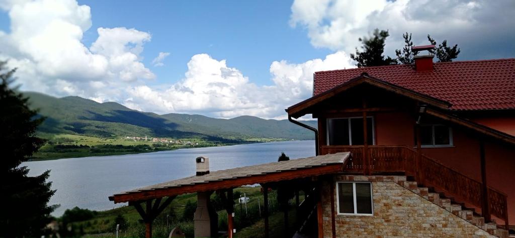 a house with a view of a lake and mountains at Къща за гости Джамбазови in Sarnitsa
