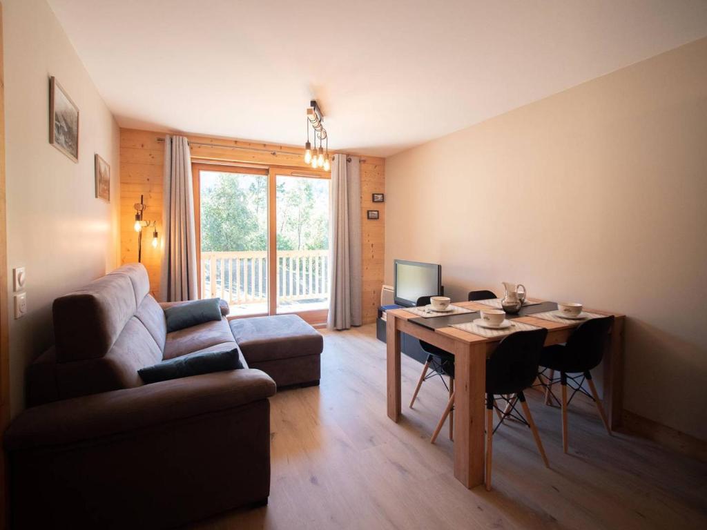 a living room with a couch and a table at Appartement Les Avanchers-Valmorel, 2 pièces, 4 personnes - FR-1-291-867 in Valmorel