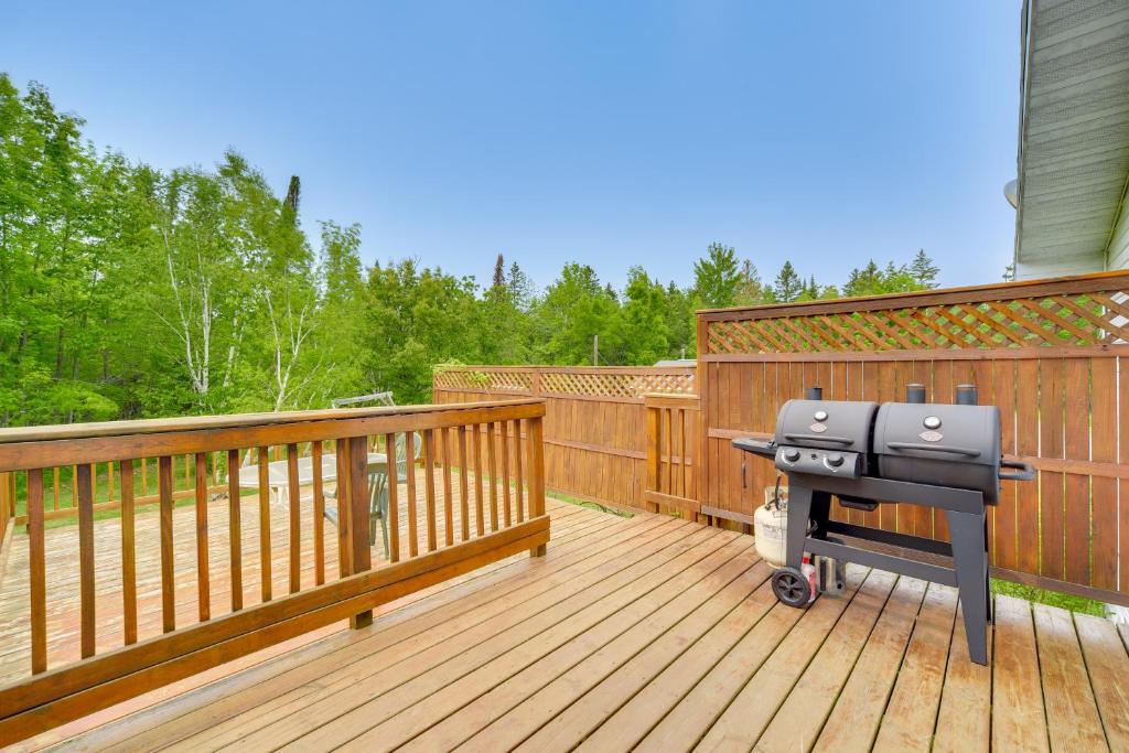 a barbecue grill sitting on a wooden deck at South Range Home - 6 Mi to Lake Superior! in South Range