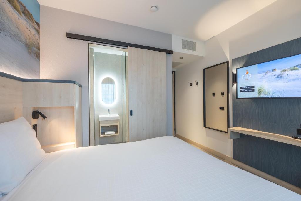 Postel nebo postele na pokoji v ubytování Fox Hotel The Hague Scheveningen
