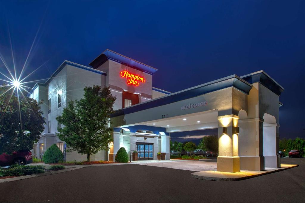 a hotel building with a neon sign on it at Hampton Inn Clarion in Clarion