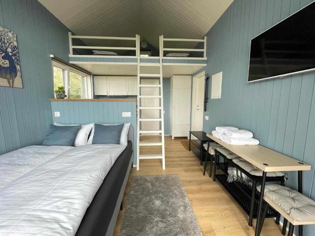 a room with a bed and a desk and bunk beds at Amma Jóna in Hvolsvöllur