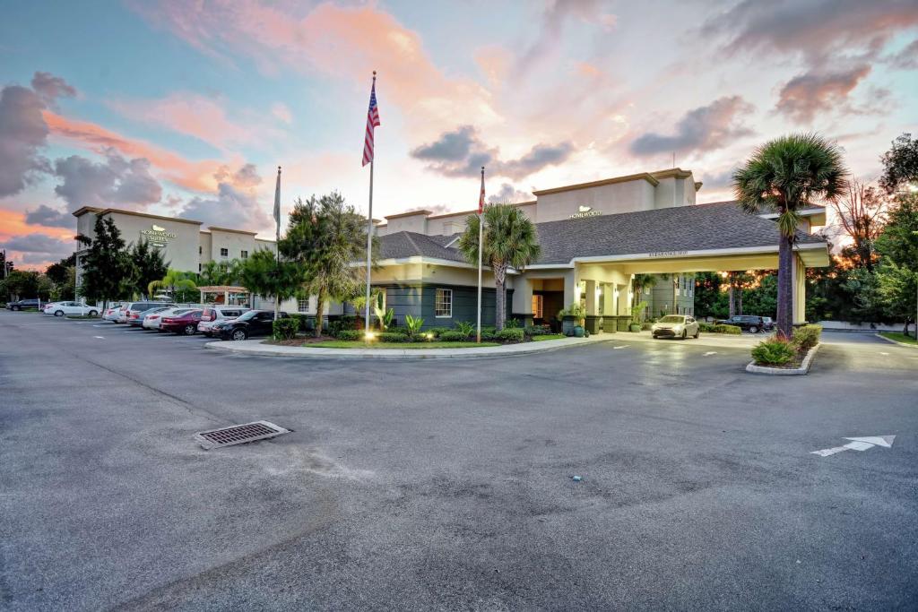 a hotel with a flag in a parking lot at Homewood Suites by Hilton Tampa-Port Richey in Port Richey