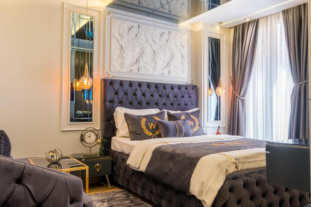 a bedroom with a large bed with a blue headboard at Wind Suit in Istanbul