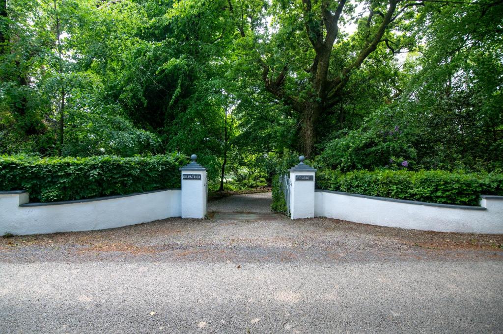 a pair of gates in a park with trees at Kilpatrick Glebe in Crossabeg