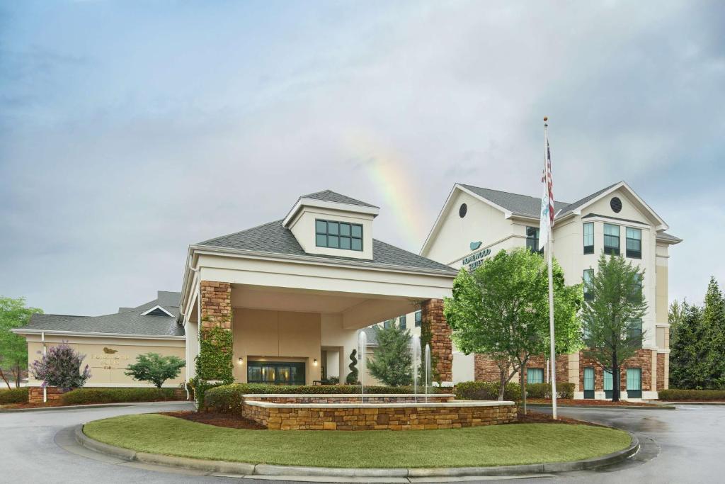 a large house with a flag in front of it at Homewood Suites by Hilton Columbus in Columbus