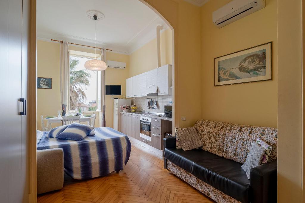 a living room with a couch and a kitchen at Solo a Sanremo in Sanremo