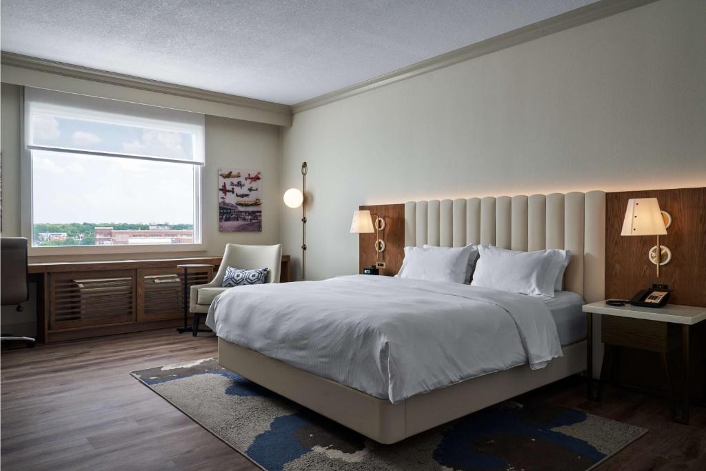 a bedroom with a large bed and a window at DoubleTree by Hilton Hotel Dallas - Love Field in Dallas