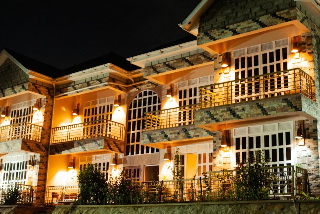 a building with balconies and lights at night at Jet Villas Entebbe ( JVE ) in Entebbe