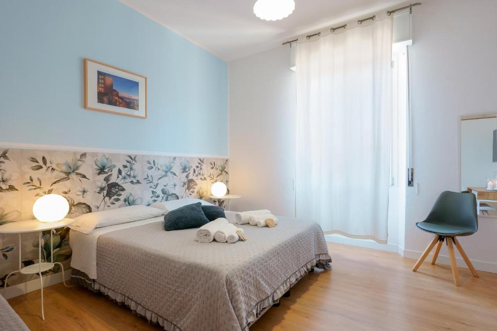 a bedroom with a bed with two stuffed animals on it at Bissenti Rooms - Eja Sardinia in Cagliari