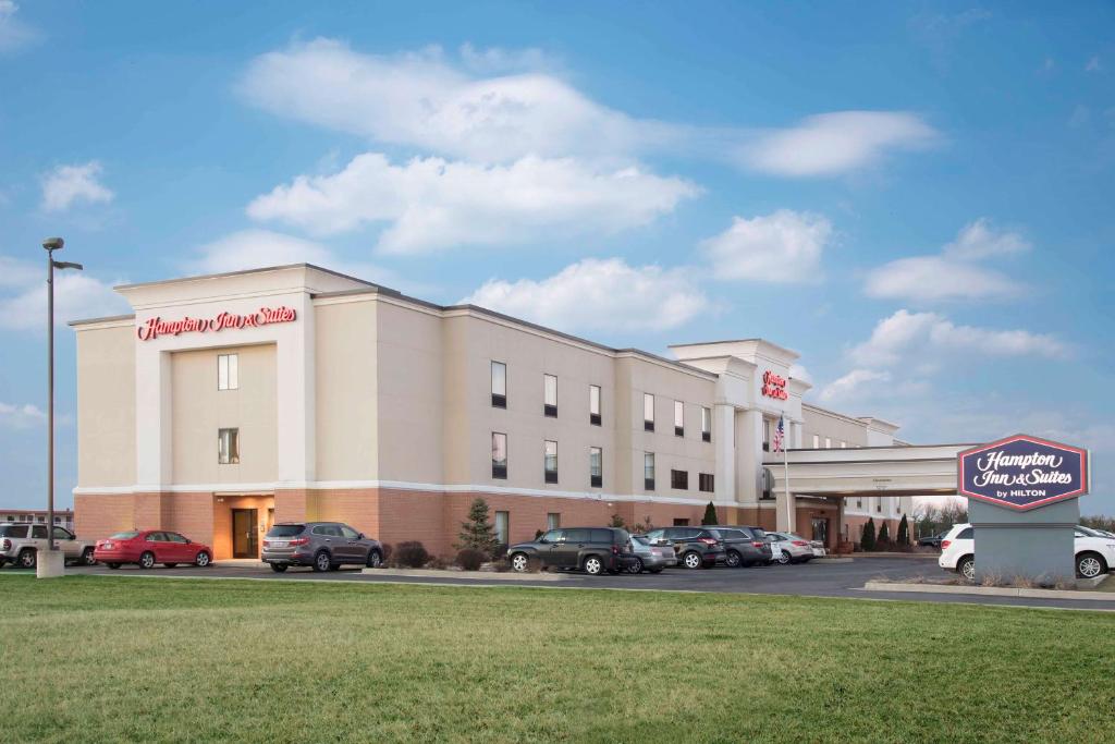 un gran edificio con coches estacionados en un estacionamiento en Hampton Inn & Suites Danville en Danville